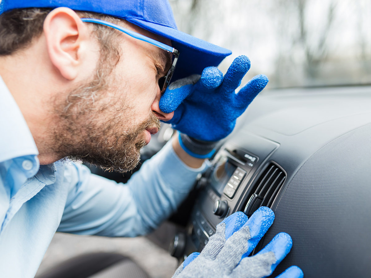 Worker Protecting His Nose From Car Air Conditioner Bad Smell.