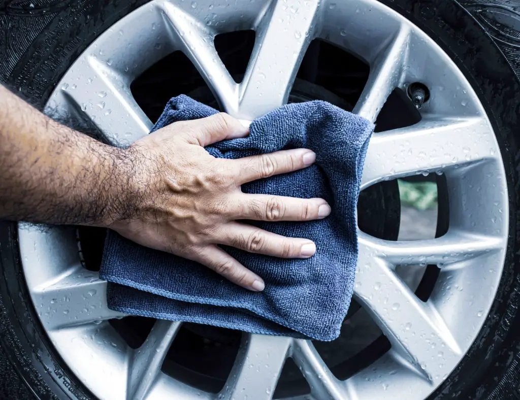 Human Hand Is Wipe Alloy Wheel Car With Microfiber Cloth
